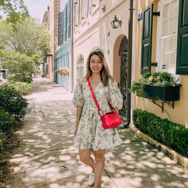 Floral Zimmerman dress on Charleston Rainbow Row in front of colorful houses